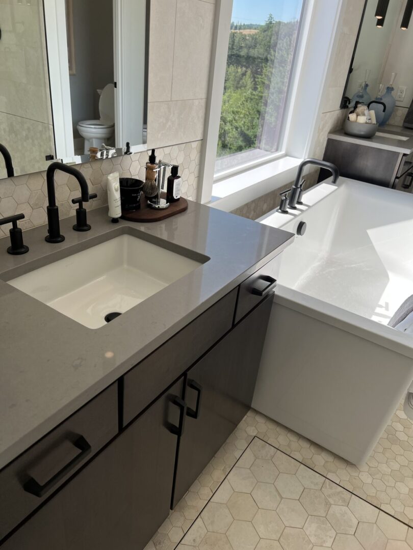 A bathroom with a sink and tub in it