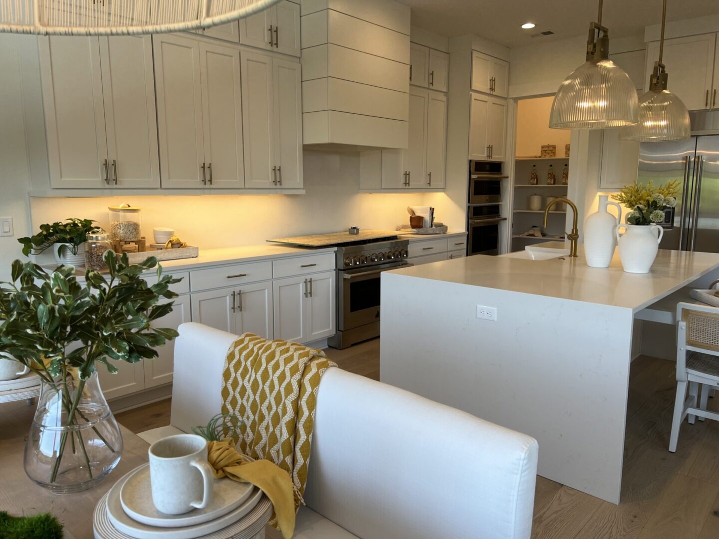 A kitchen with white cabinets and a table