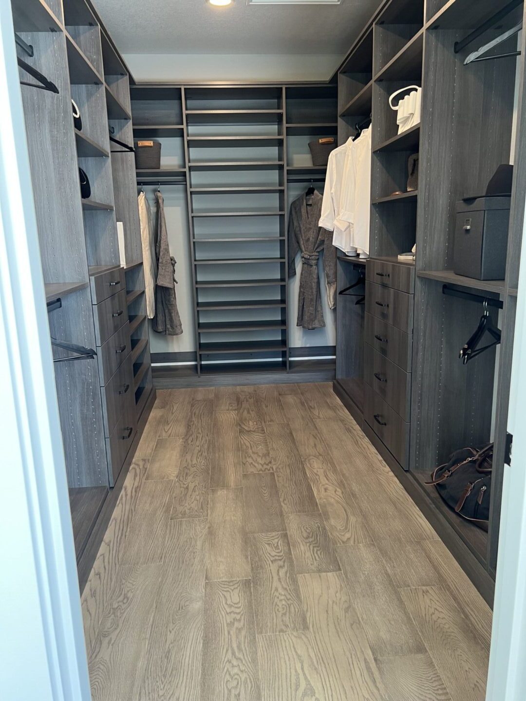 A master bedroom closet with built-in cabinetry.