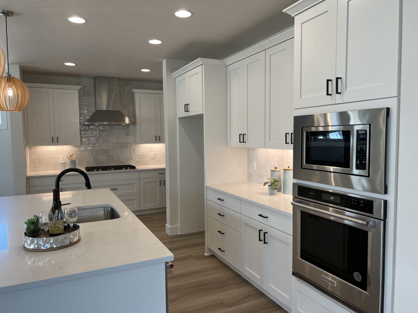 A kitchen with white cabinets and white counters.