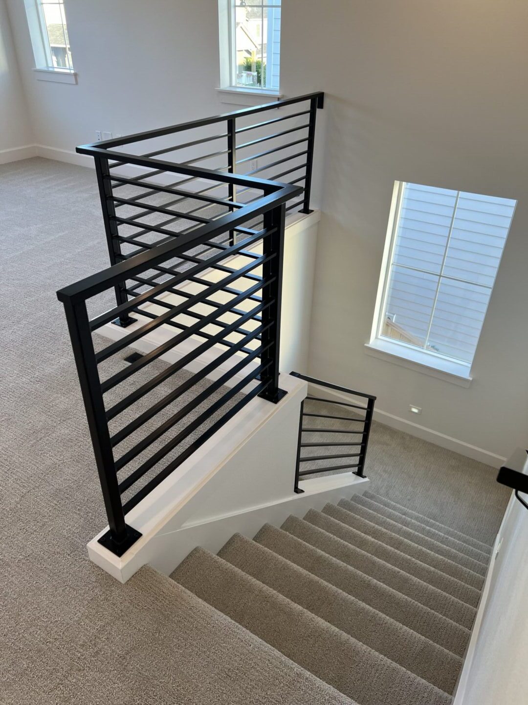 A black handrail with white molding.